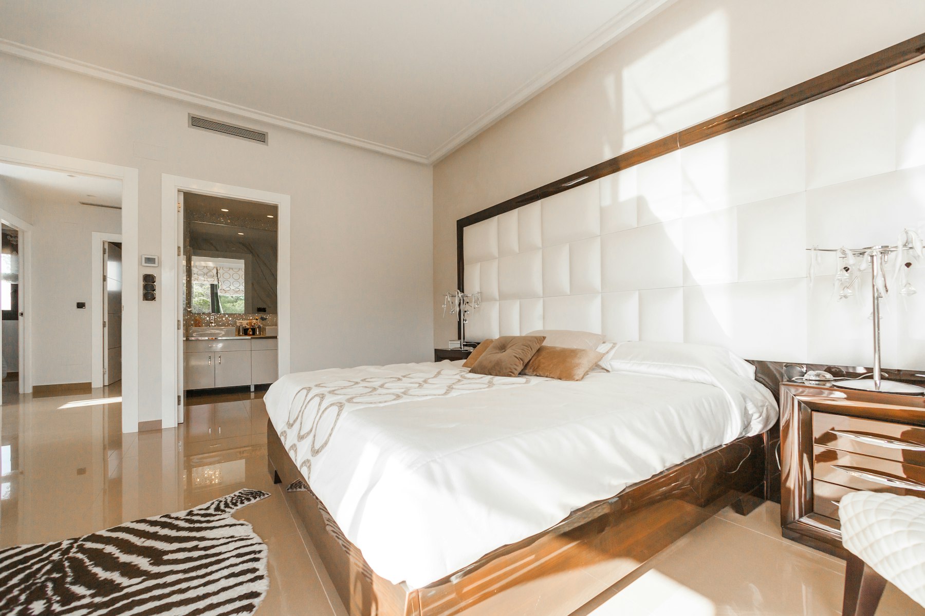 The Cork House — white linen bed beside tall shuttered windows