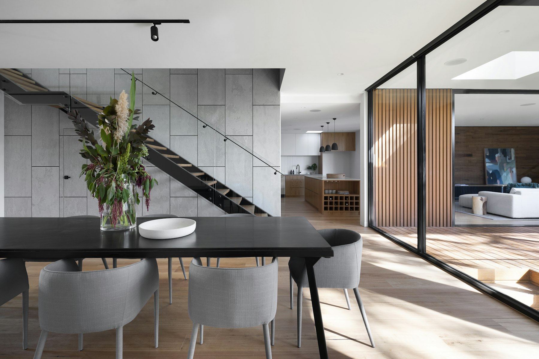 Double-height dining space with glass walls