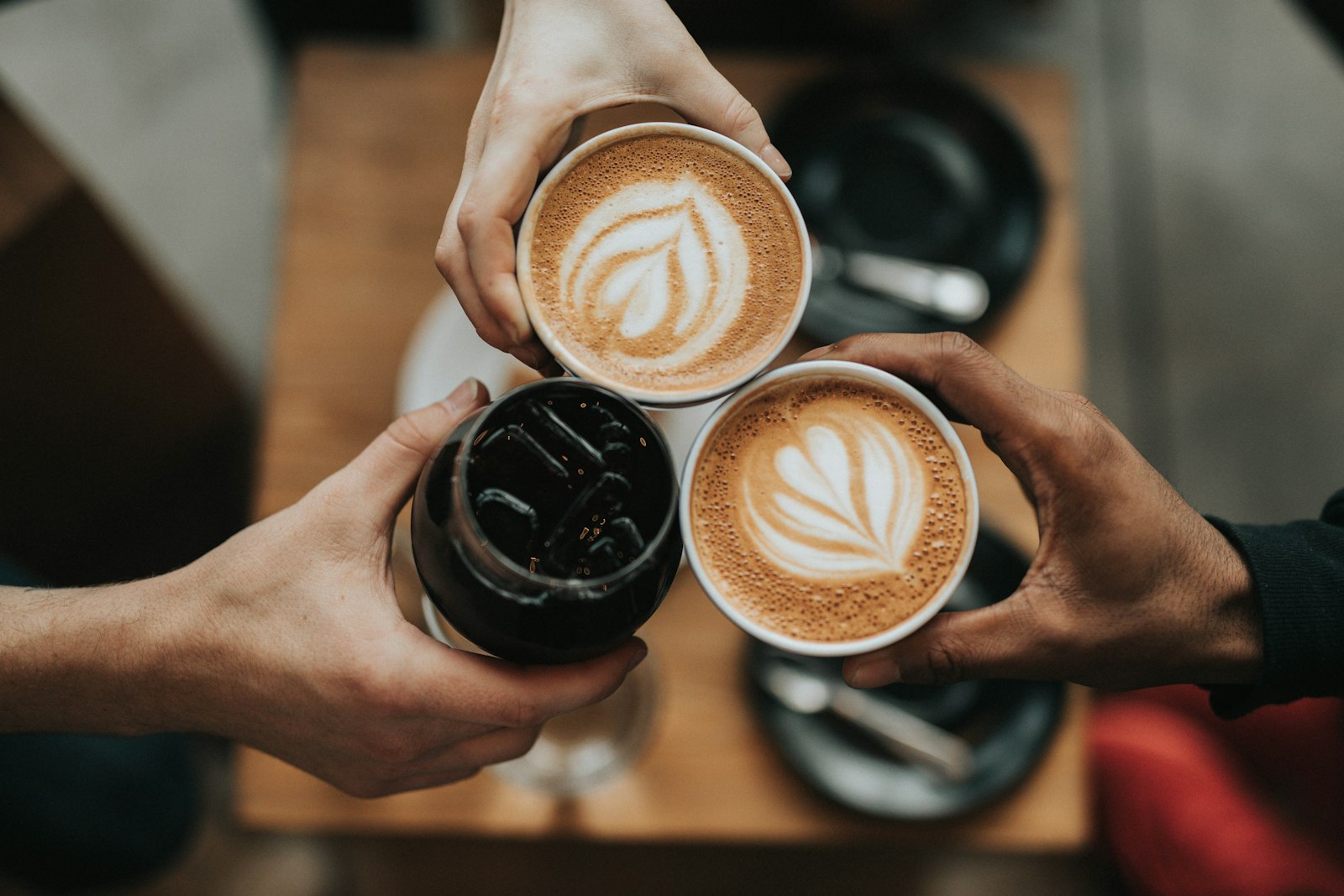 Two lattes toasting